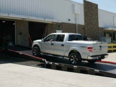 Pickup truck driving up loading dock ramp