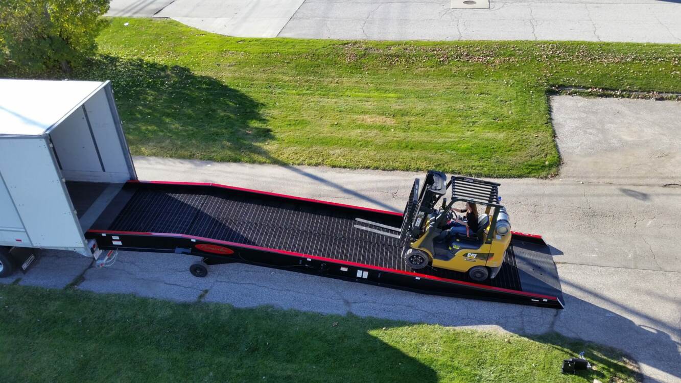 Forklift heading towards open truck trailer using a Copperloy yard ramp